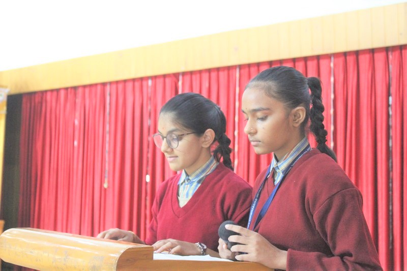 Students participating in various activities during English Week at school assembly
