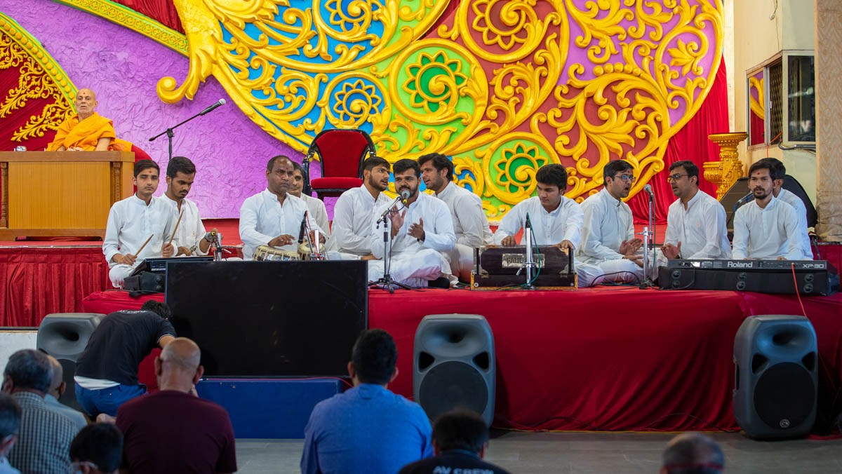 Youths sing kirtans in the evening Sunday satsang assembly