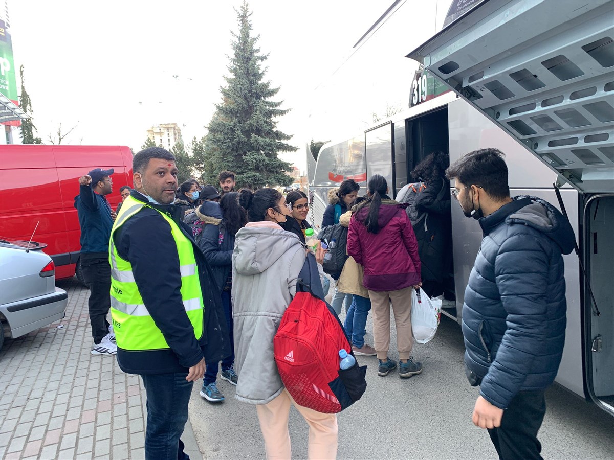 The refugees were helped onto buses to the airport for flights back to India
