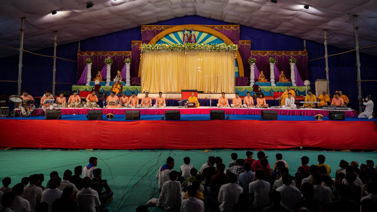 Sadhus and youths present the kirtan aradhana