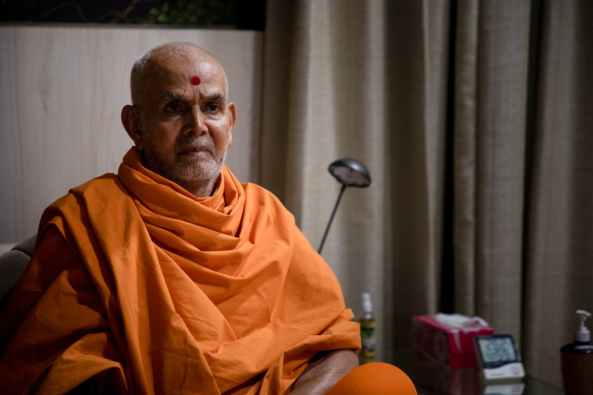 Swamishri watches a video