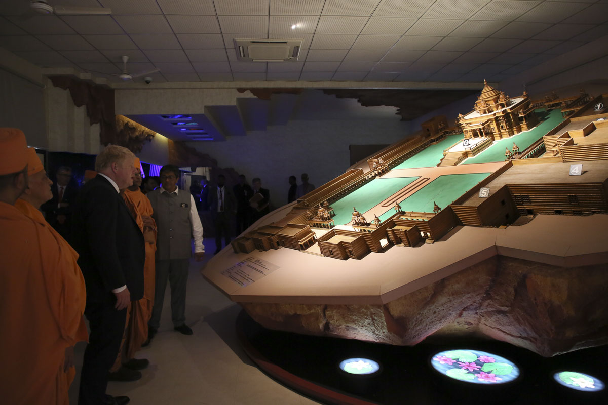 PM Boris Johnson observes a model of Akshardham