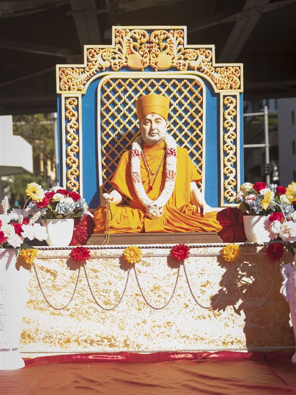 Brahmaswarup Pramukh Swami Maharaj on a decorative chariot
