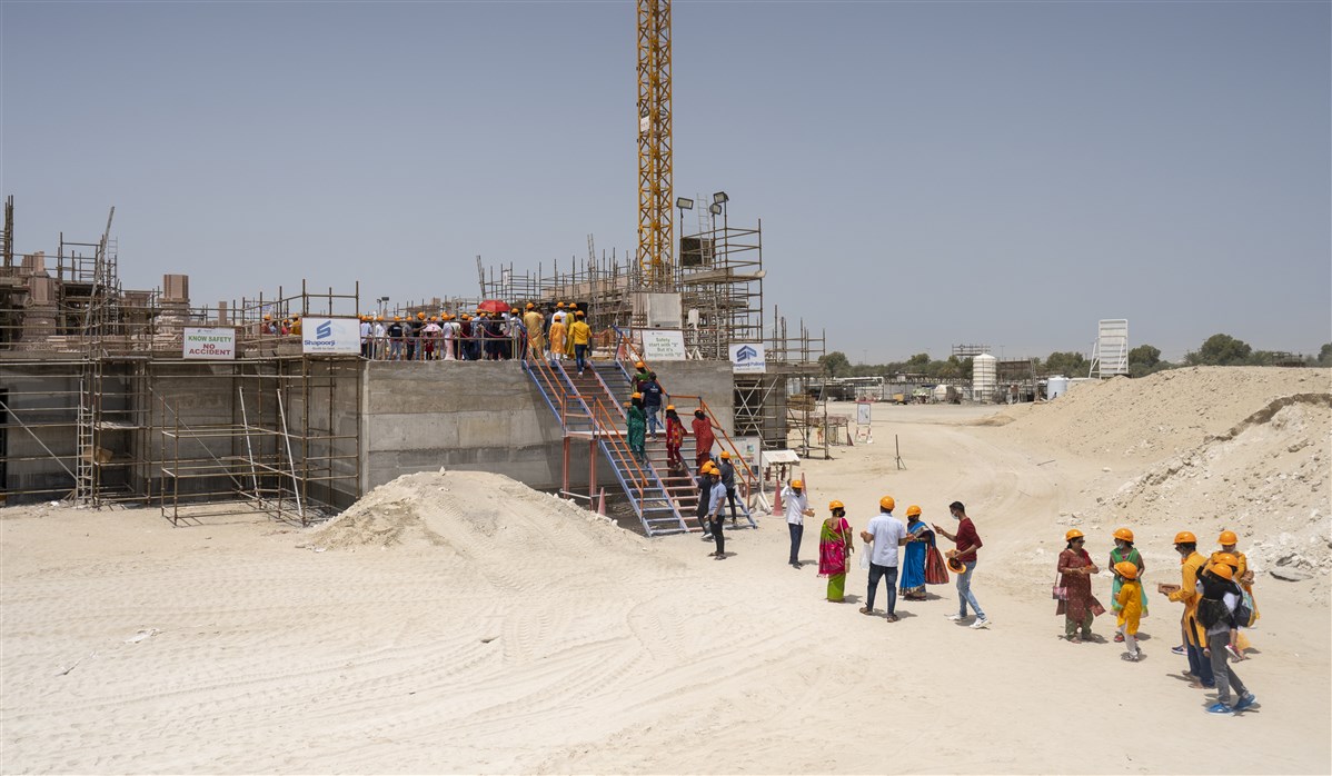 Attendees make their way up to lay bricks for the new upcoming mandir