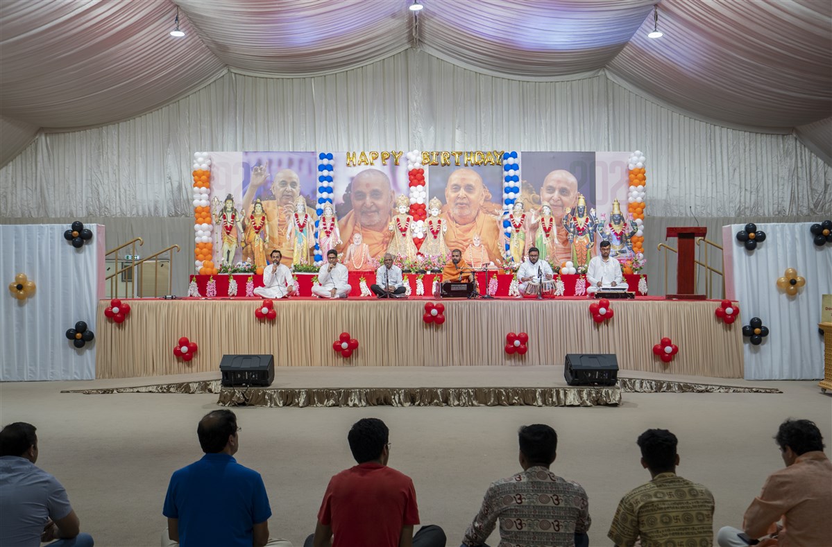 Devotees engaged in listening to bhajans
