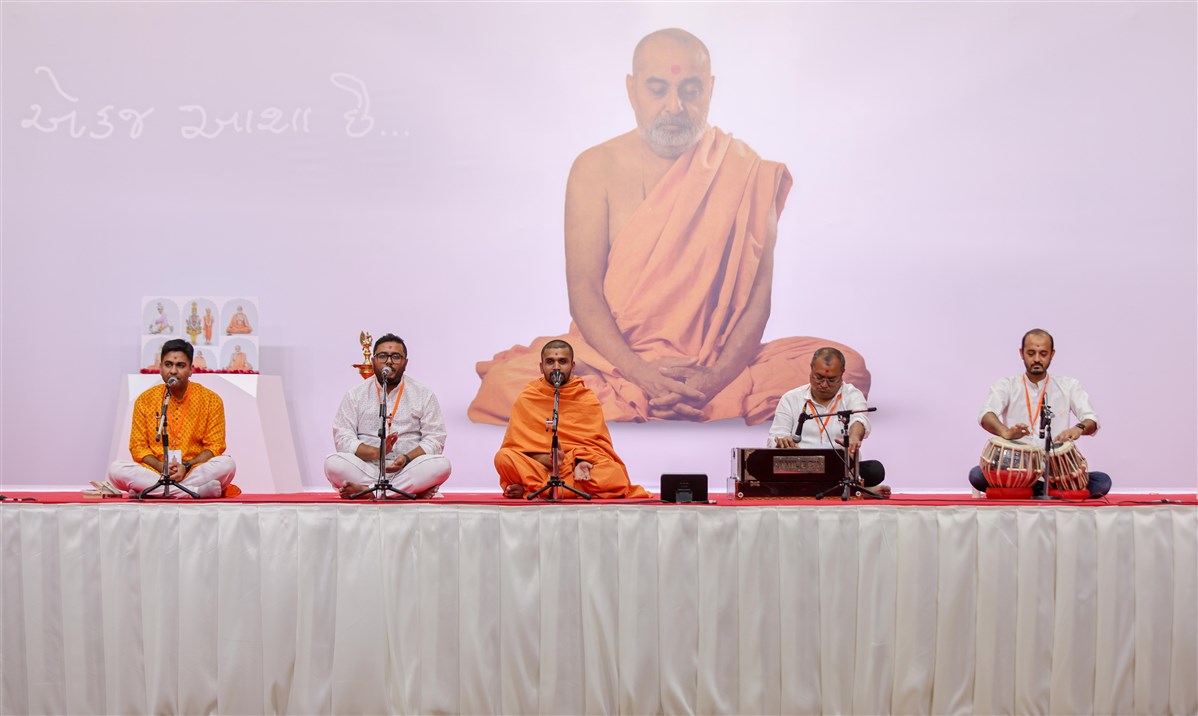 Swami Gurunayandas  and youths sing devotional songs