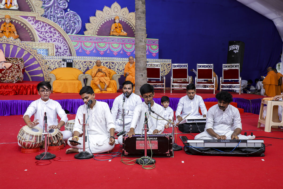 Youths sing kirtans in the assembly