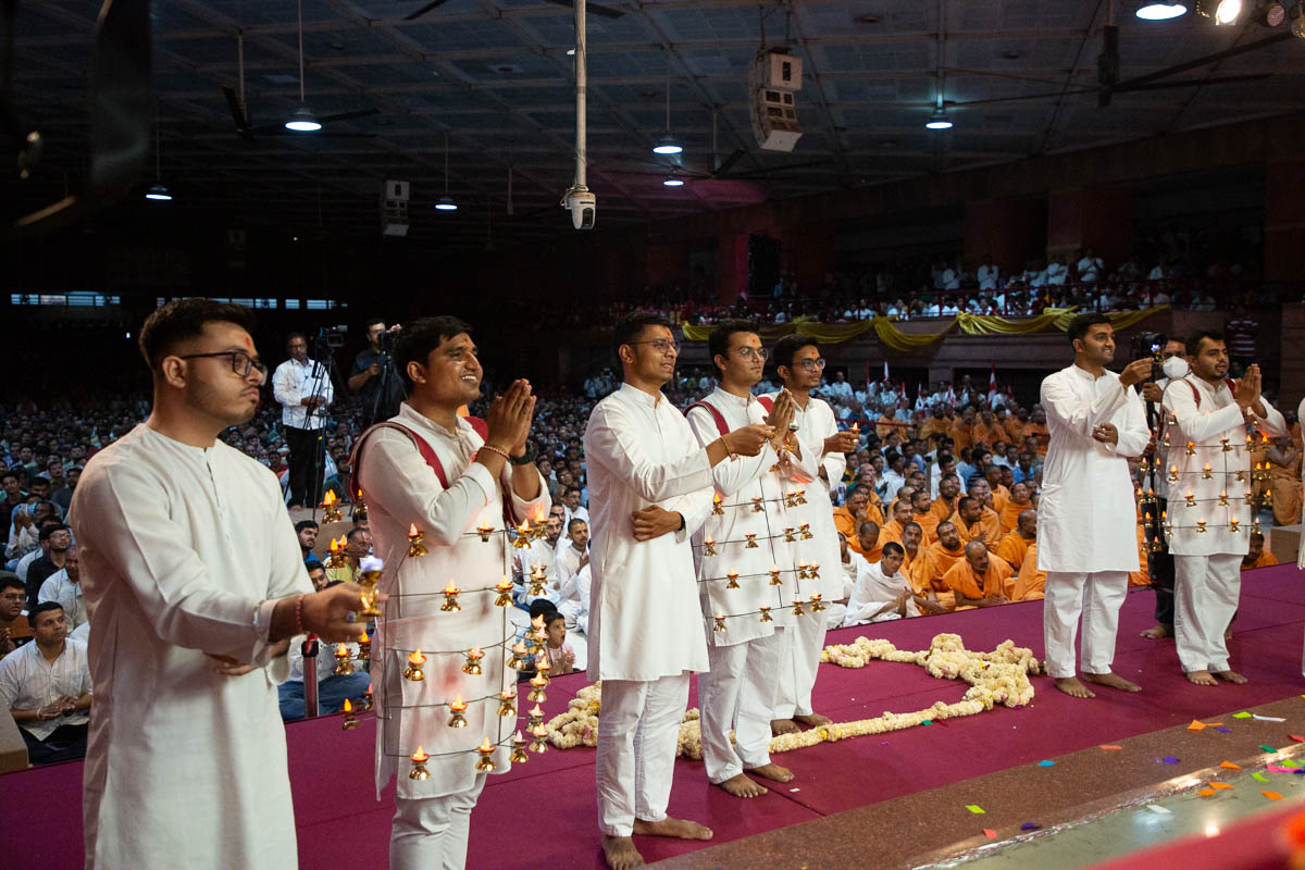 Youths perform the arti