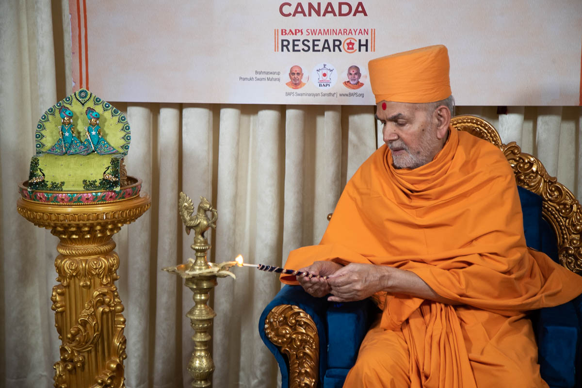 Swamishri lights the inaugural lamp for the BAPS Swaminarayan Research Institute, Canada