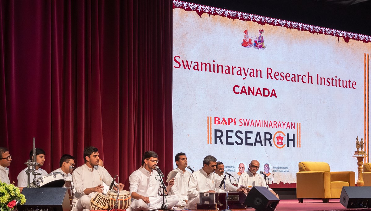 Youths begin the inauguration assembly with bhajans