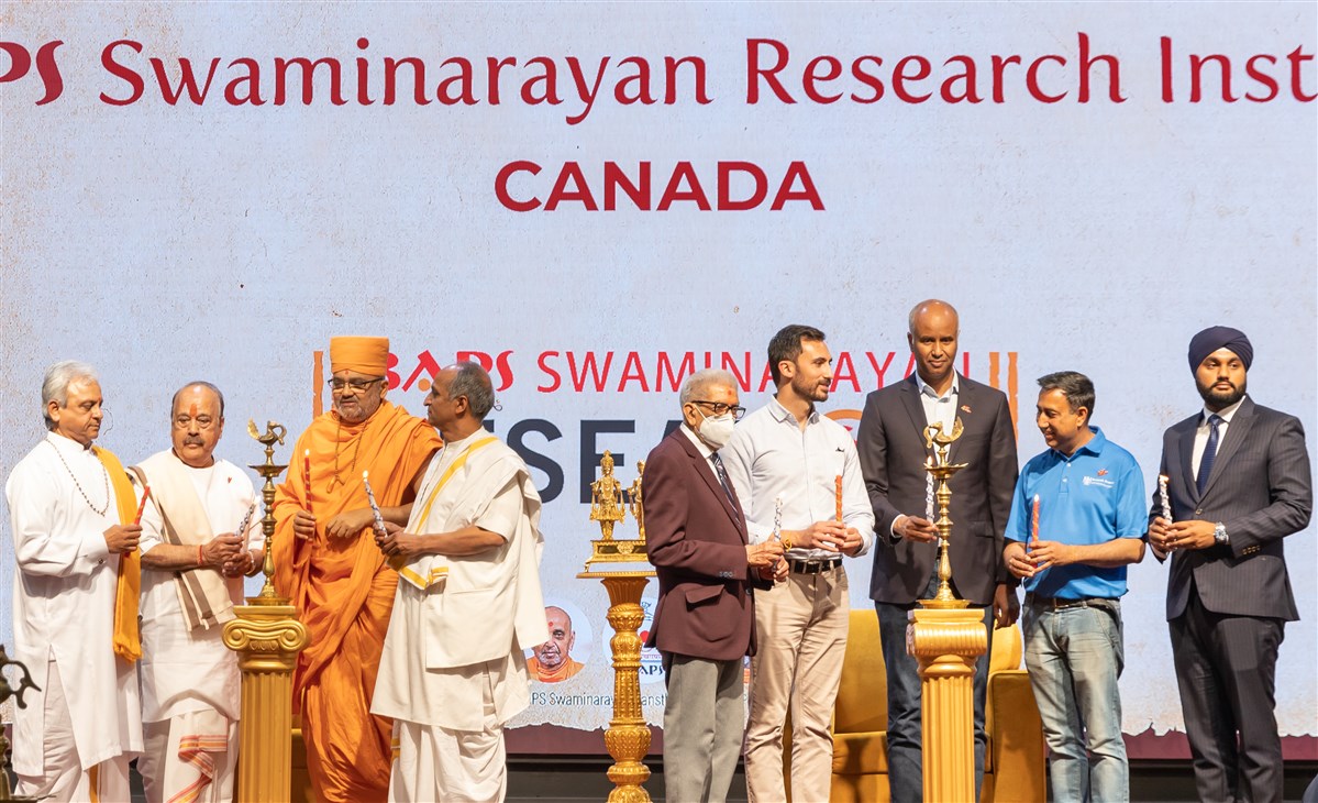 The stage guests ceremoniously light the lamps to mark the inauguration of the research institute