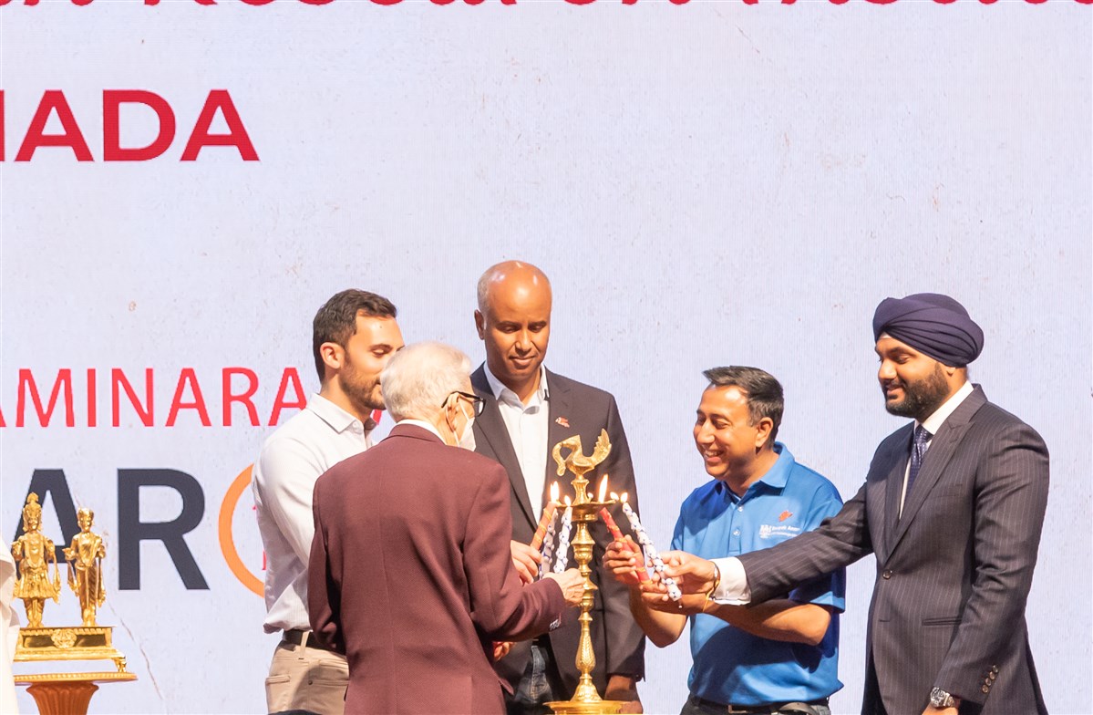 The stage guests ceremoniously light the lamps to mark the inauguration of the research institute