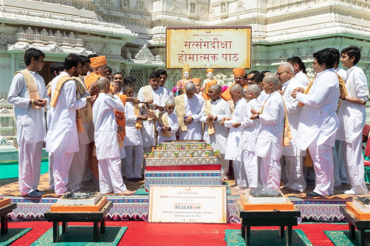 Children and Youth participate in the yagna by offering sanctified grains in the sacrificial flame