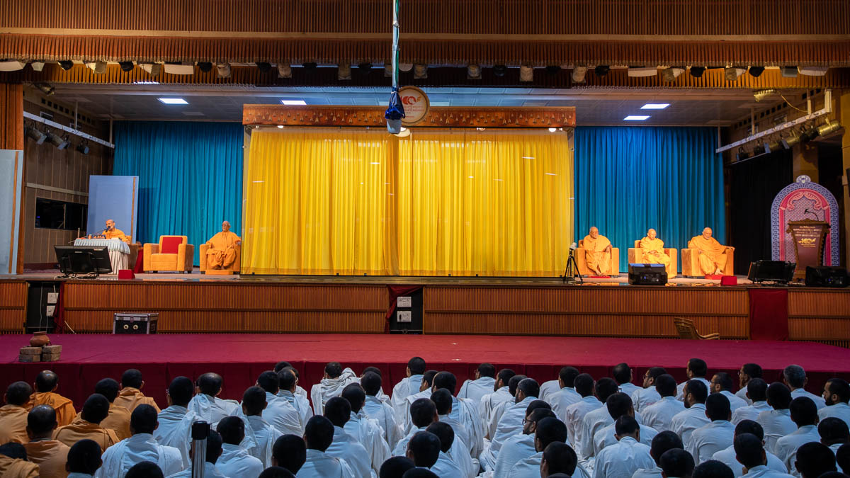 Senior sadhus on the stage during the evening Sunday satsang assembly