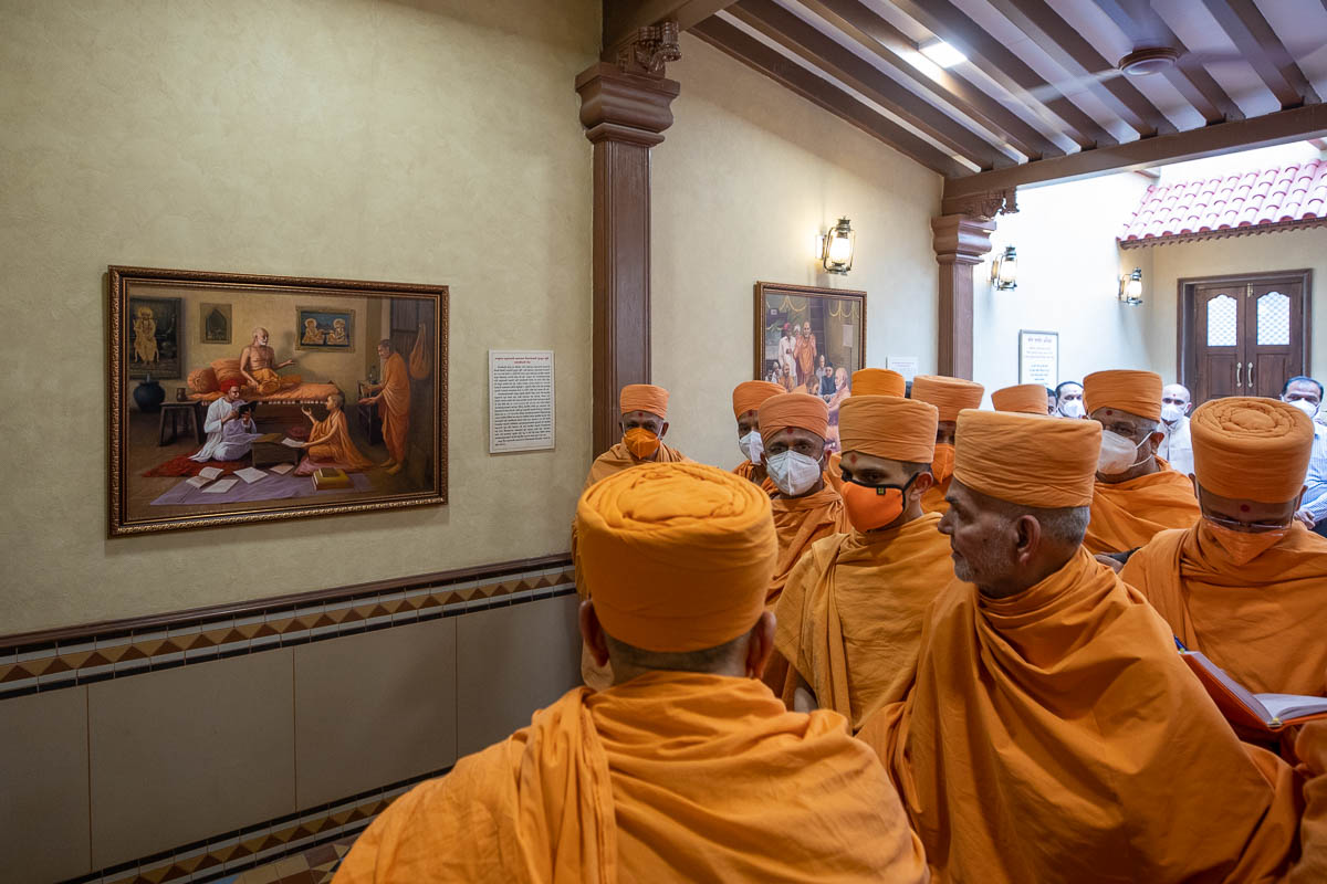 Swamishri observes a painting of Narayanswarupdas Swami taking his first Sanskrit class from Brahmaswarup Shastriji Maharaj