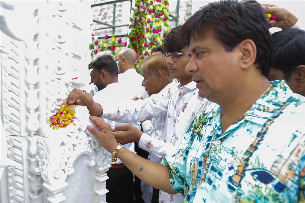 Devotees offer flower petals