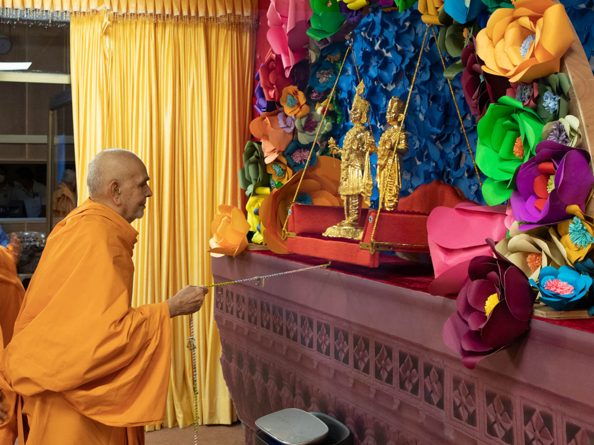 Swamishri swings Shri Akshar-Purushottam Maharaj on a hindolo