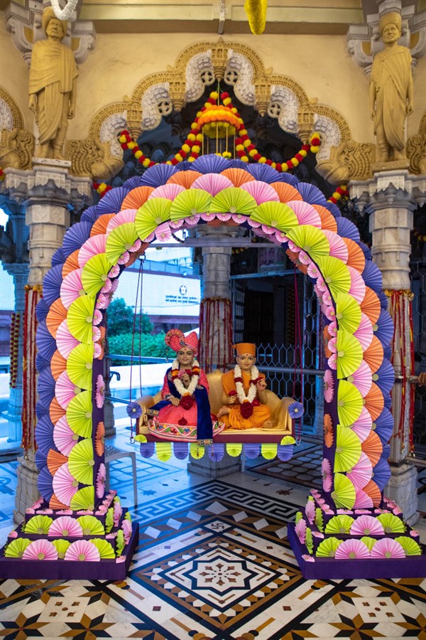Bhagwan Swaminarayan and Aksharbrahma Gunatitand Swami in a decorative hindolo
