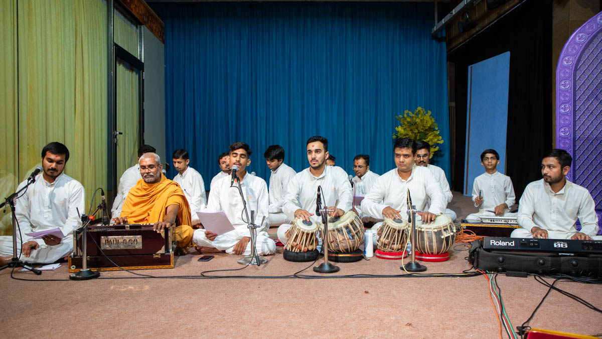 Youths sing kirtans in the Sunday evening satsang assembly
