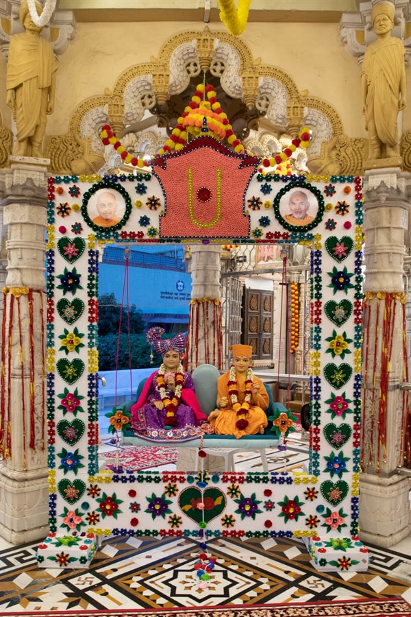 Bhagwan Swaminarayan and Aksharbrahma Gunatitanand Swami in a decorative hindolo