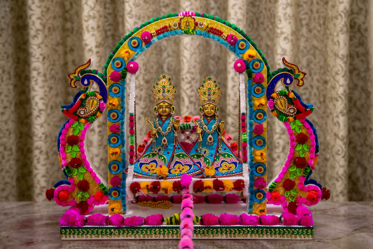 Shri Harikrishna Maharaj and Shri Gunatitanand Swami in a decorative hindolo