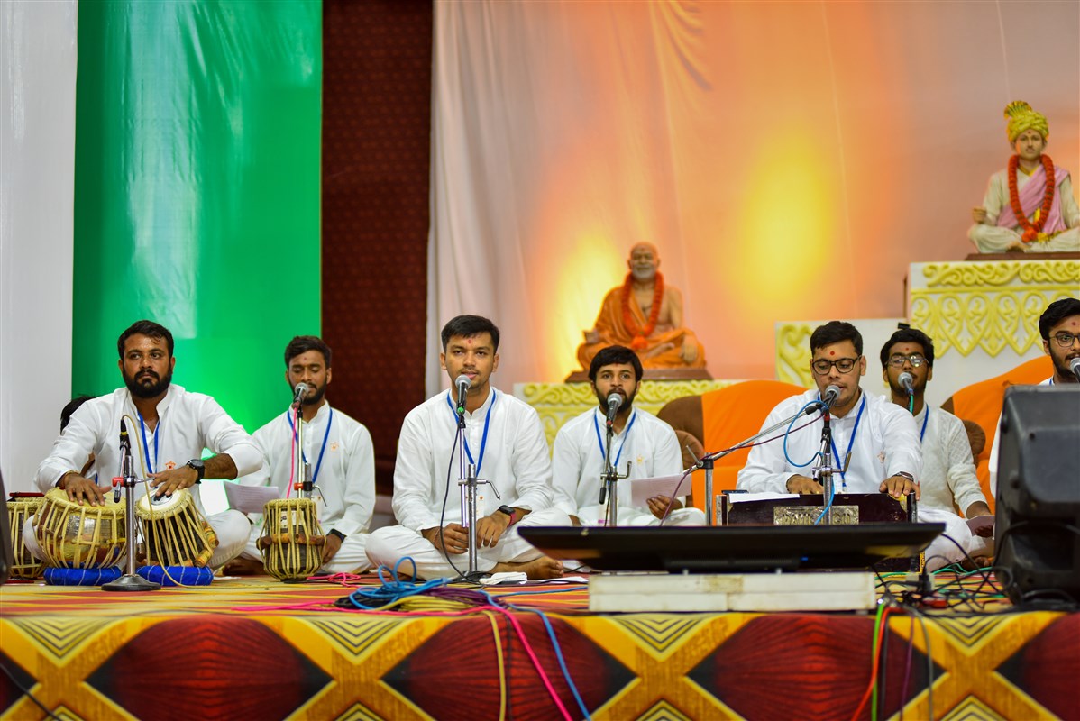 Youths sing kirtans in the welcome assembly in the evening