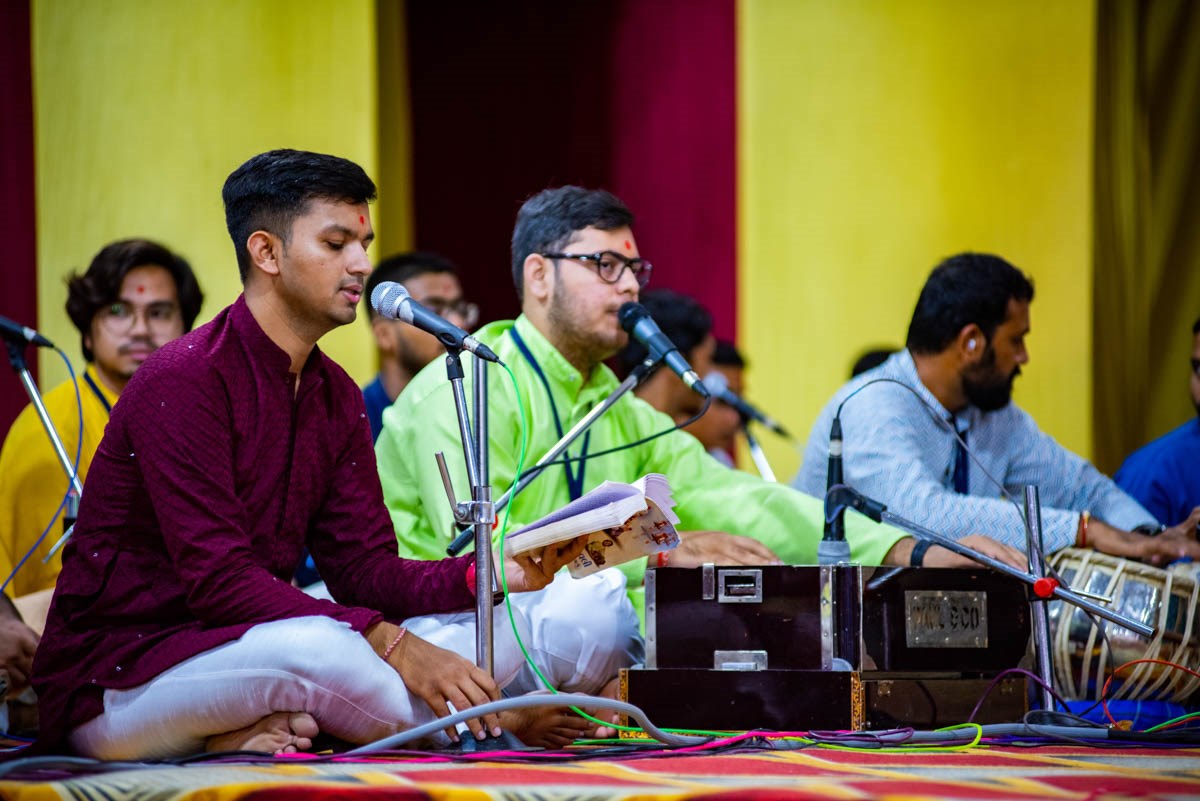 Youths sing kirtans in the Shri Krishna Janmashtami celebration assembly in the evening