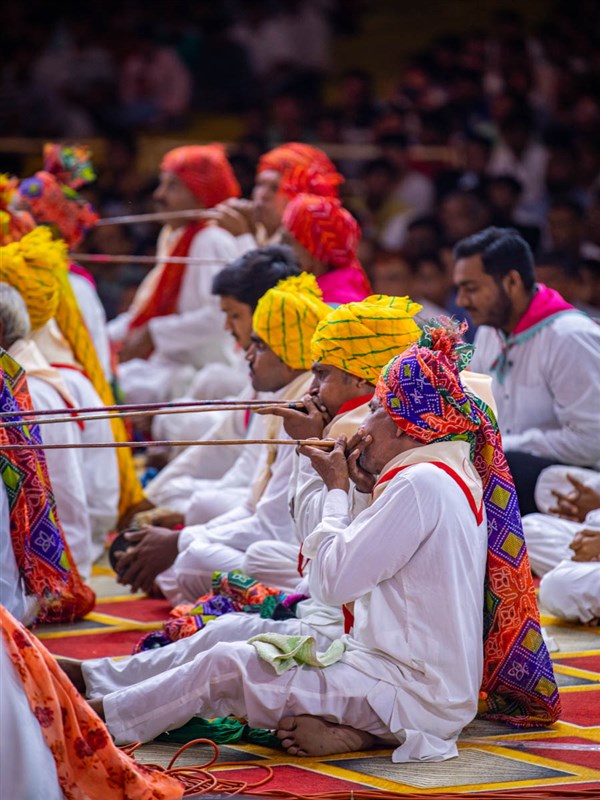 Devotees play a traditional instrument