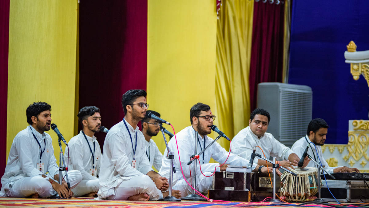 Youths sing kirtans in the evening satsang assembly