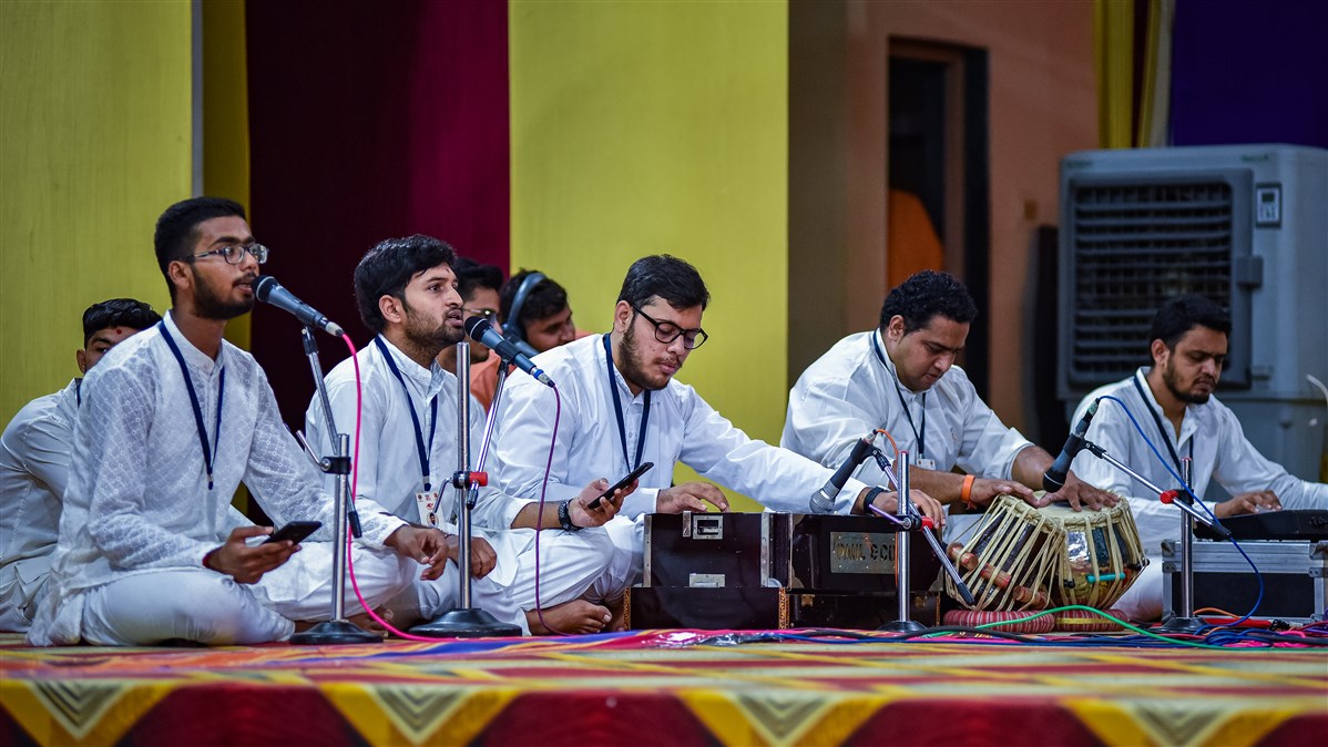 Youths sing kirtans in the evening satsang assembly