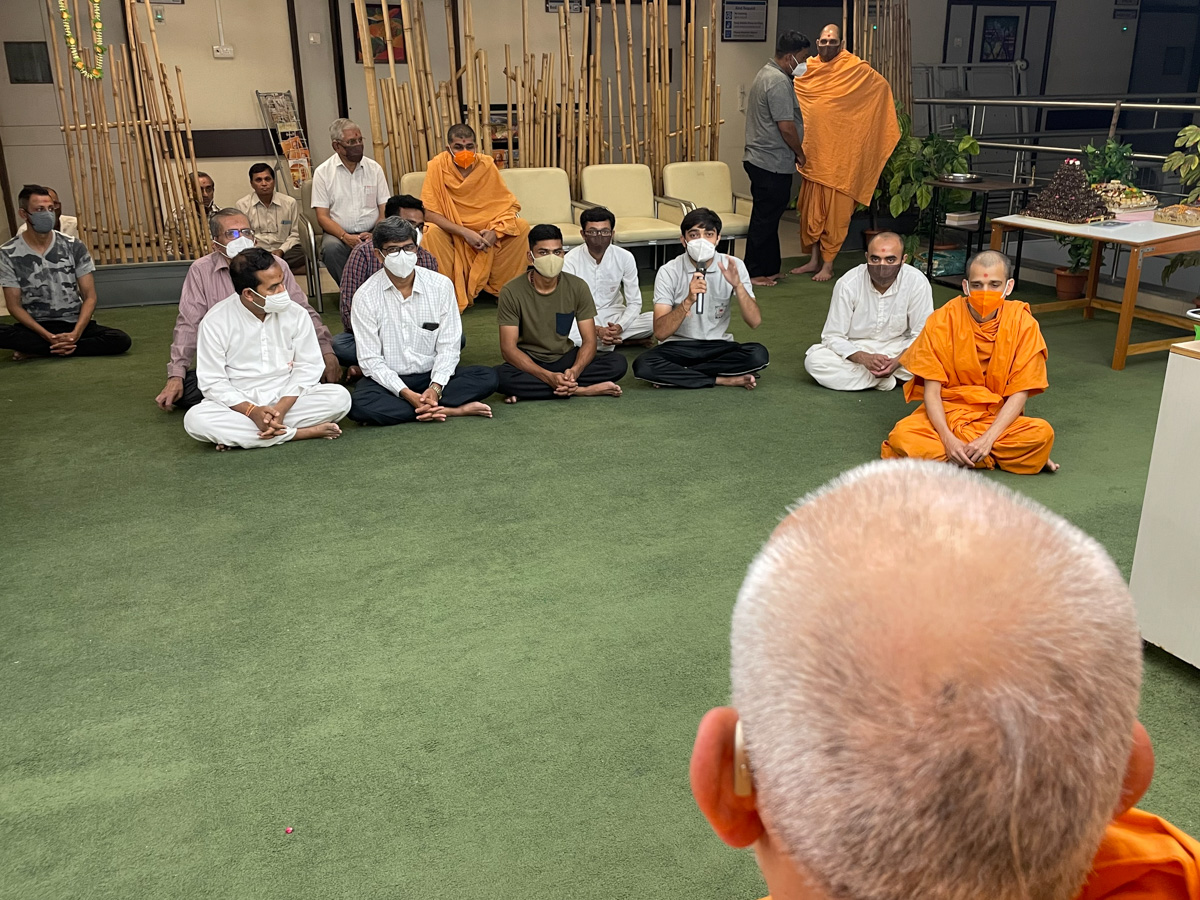 A youth in conversation with Swamishri