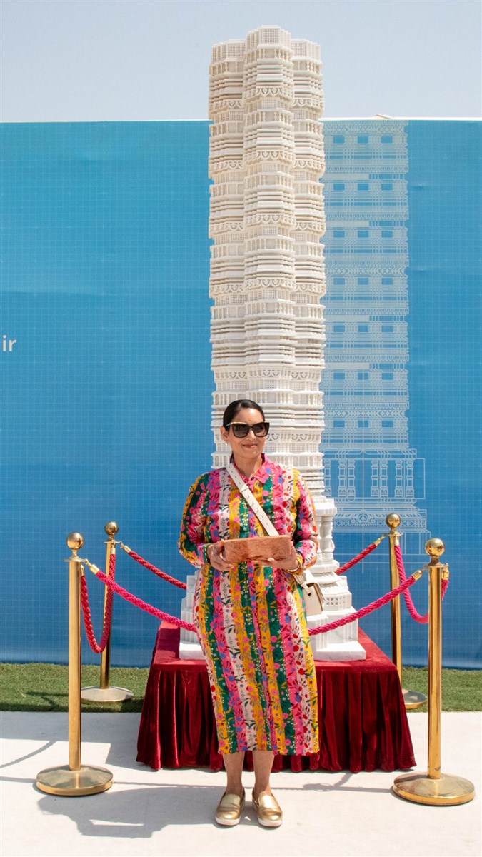 Hon. Priti Patel by an intricately carved marble pillar of the Mandir