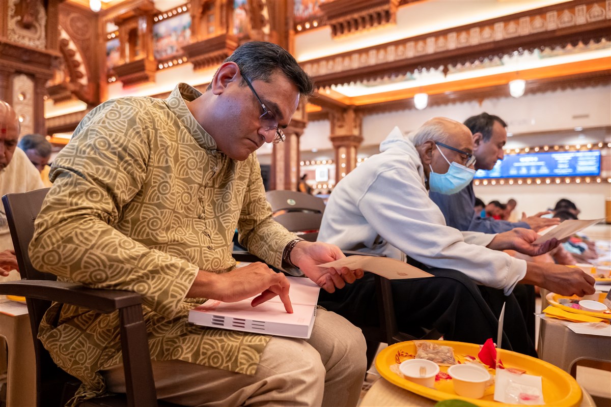 As part of the Chopda Pujan tradition, a devotee applies vermillion in his day planner.