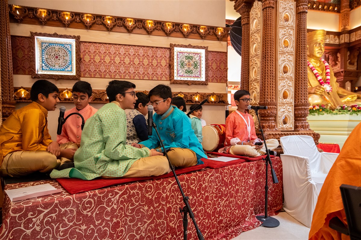 Children sing Sanskrit hymns during the Chopda Pujan.