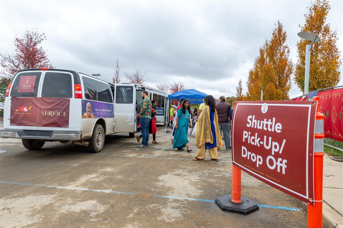 Visitors exit the shuttle which transported them from their parking spot to the pedestrian entrance.