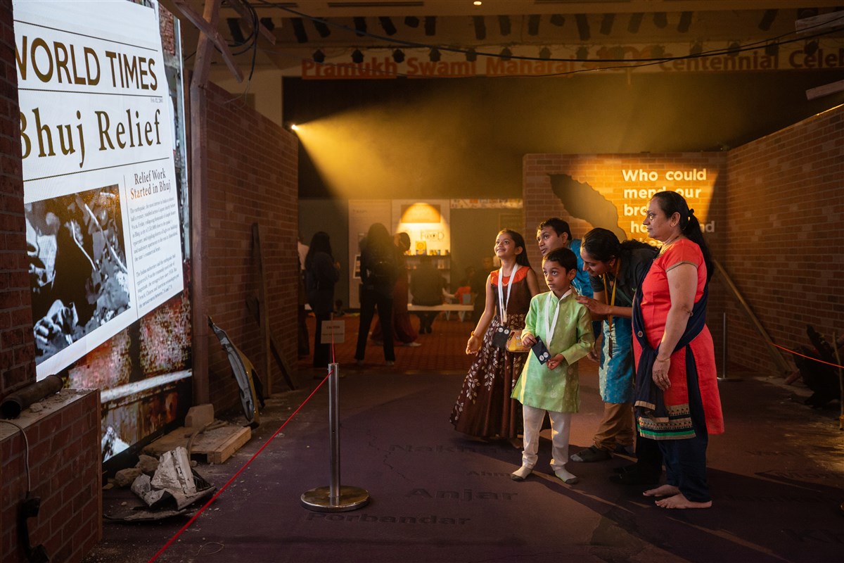 In 2001, regions of the State of Gujarat, India experienced a devasting earthquake. In the disaster relief segment of the Century of Service exhibition, a young family attentively views a digital display covering the earthquake and relief efforts initiated by Pramukh Swami Maharaj.