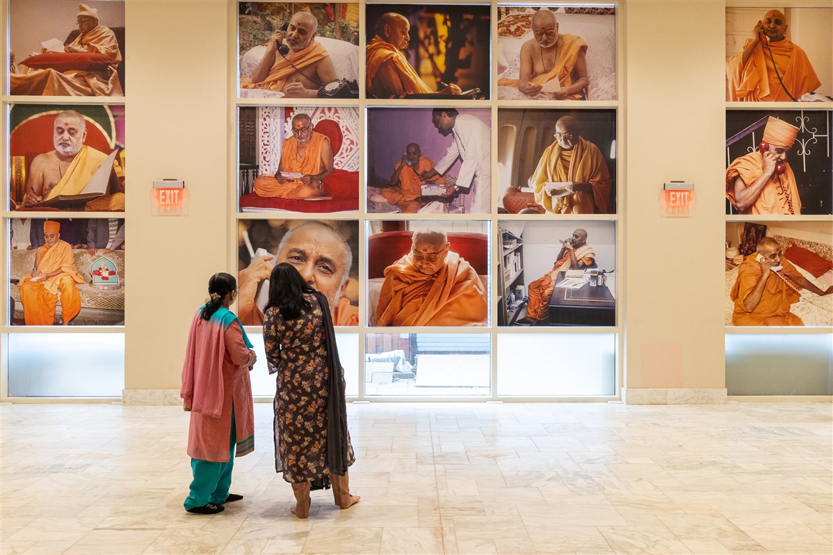 Visitors point to an image they recognize from one of the incidents from Pramukh Swami Maharaj's life.