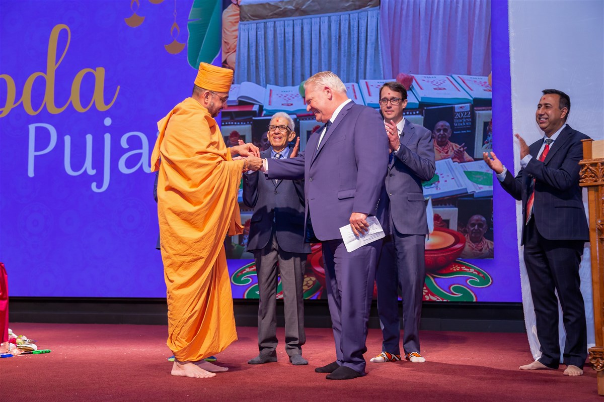 Hon. Doug Ford, Premier of Ontario, Hon. Monte McNaughton being greeted by Pujya Gunsagar swami. Also seen are Minister of Labour, Immigration, Training and Skills Development, Deepak Anand, Member of Provincial Parliament