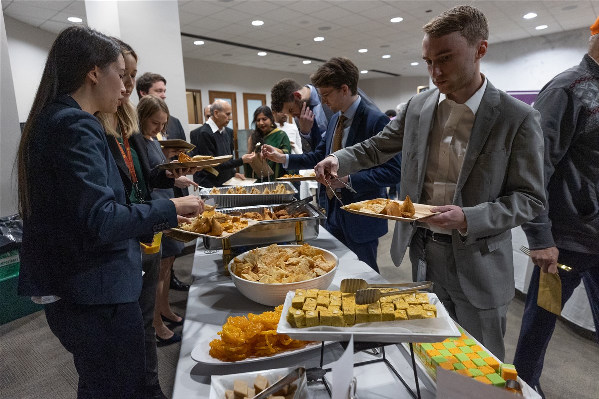 Members of Congress enjoying traditional Indian foods and sweets