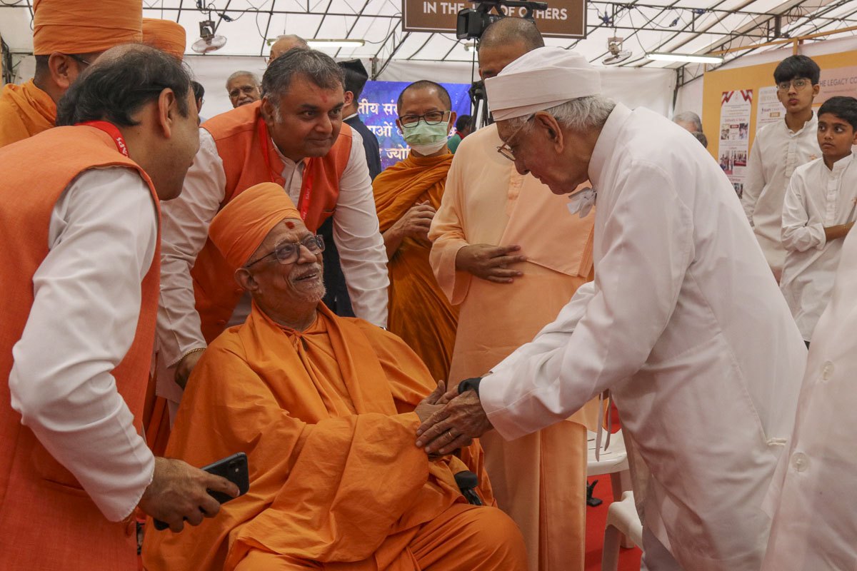 A dignitary meets Pujya Doctor Swami