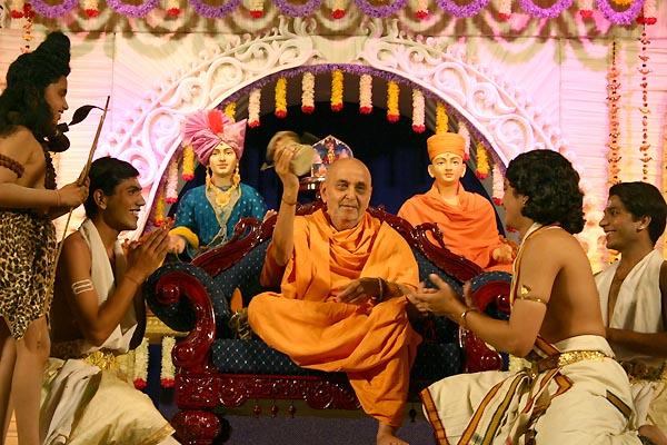 Swamishri plays the 'damru' after the youths perform a dance in honor of Lord Shivaduring the Shivratri festival celebration