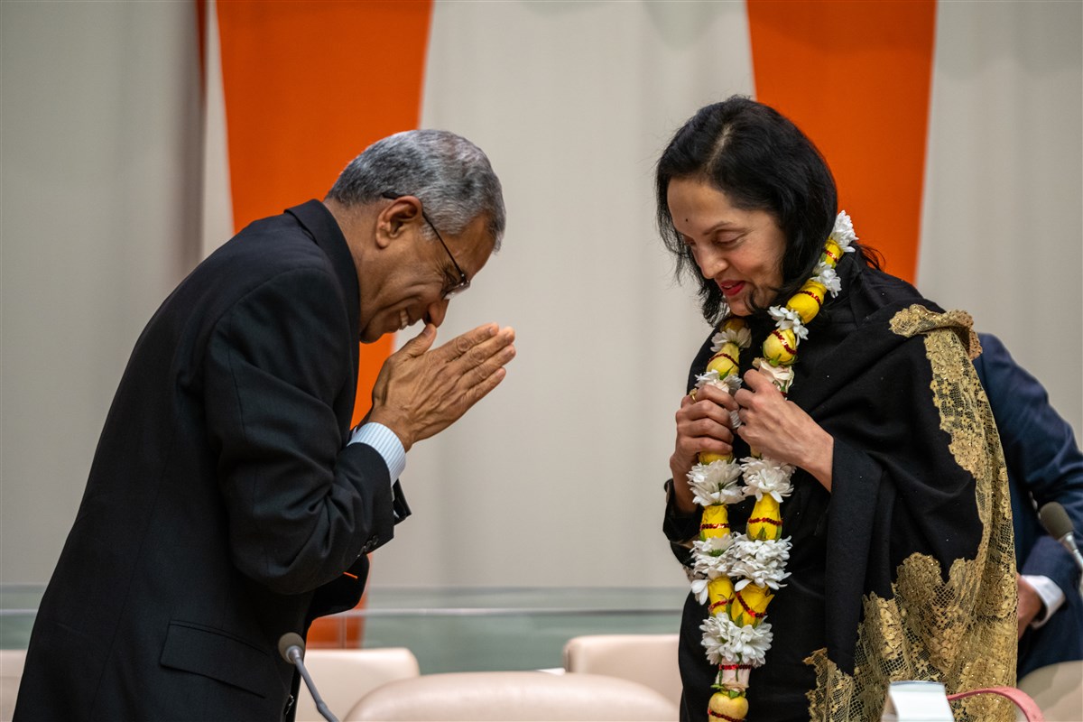 On behalf of BAPS, Shri Kanubhai Patel, CEO of BAPS North America, honors Her Excellency Mrs. Ruchira Kamboj, the Permanent Representative of India to the United Nations, with a garland as a sign of gratitude. 