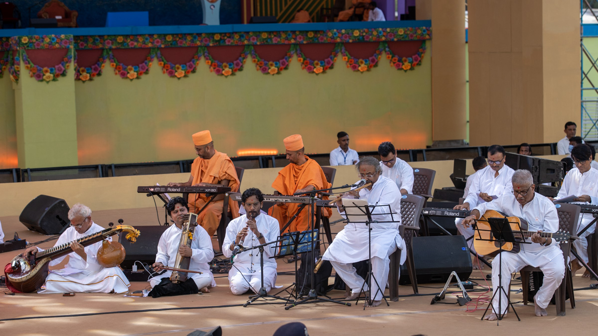 Sadhus and youths play musical instruments
