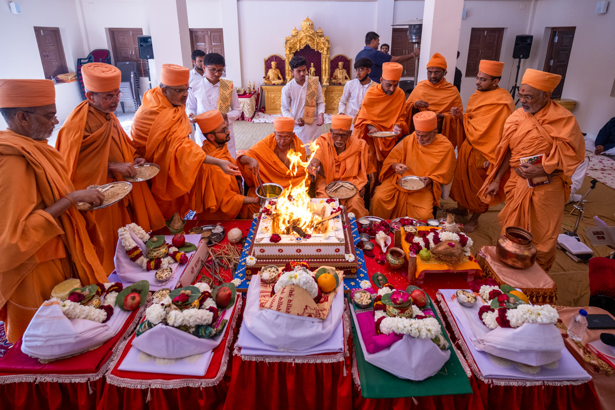Senior sadhus perform the yagna rituals