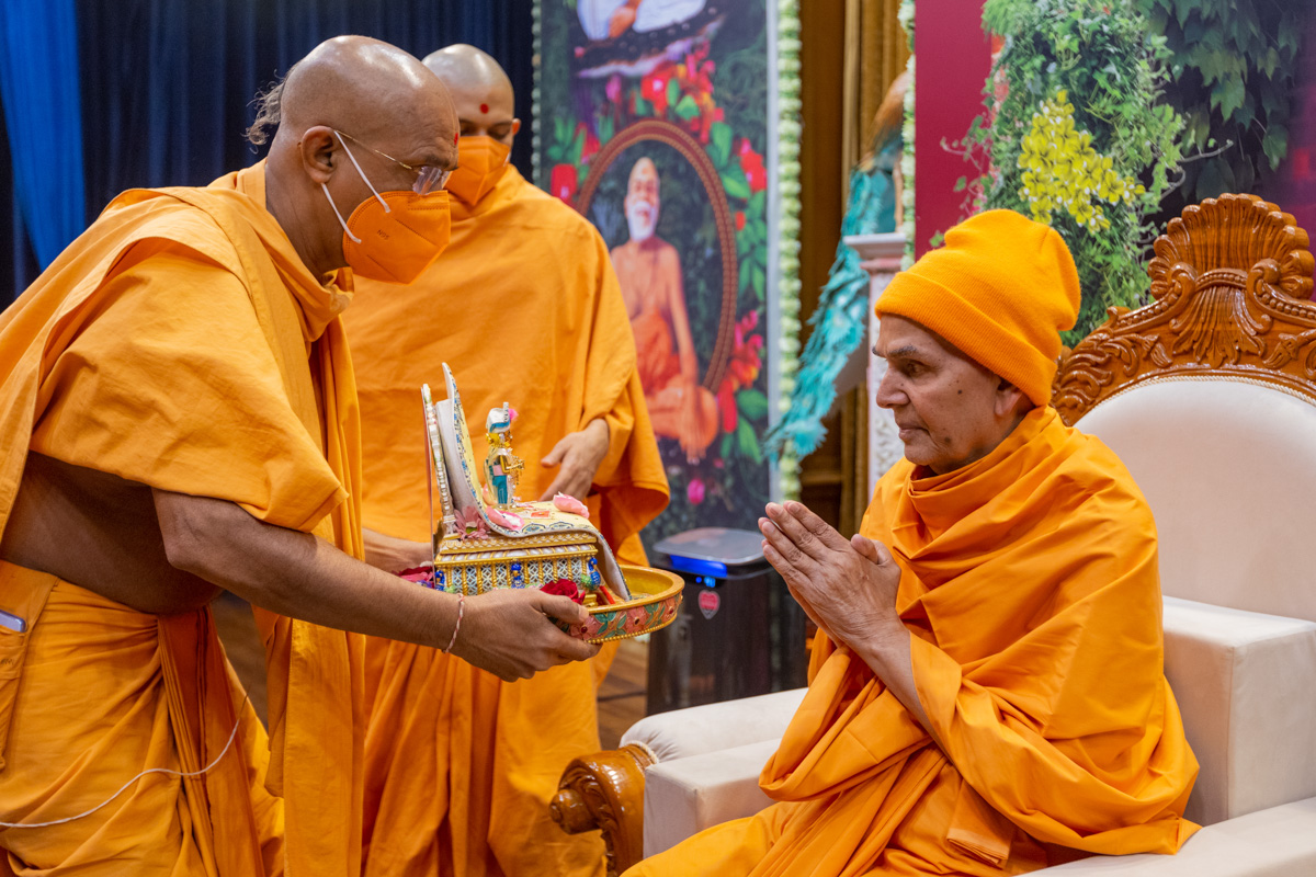 Swamishri engrossed in darshan of Shri Harikrishna Maharaj and Shri Gunatitanand Swami