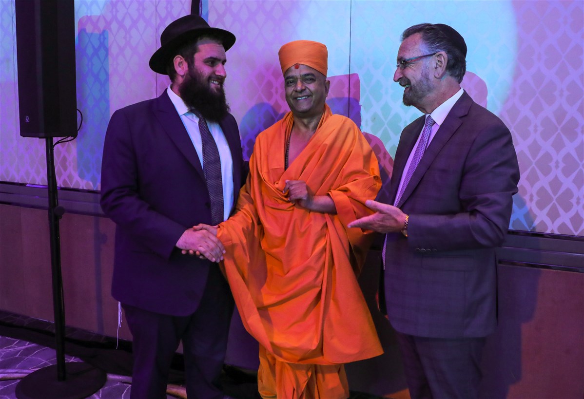Swami Brahmaviharidas, Cheif Rabbi David Rosen, and Rabbi Levi Duchman share a light moment during the summit
