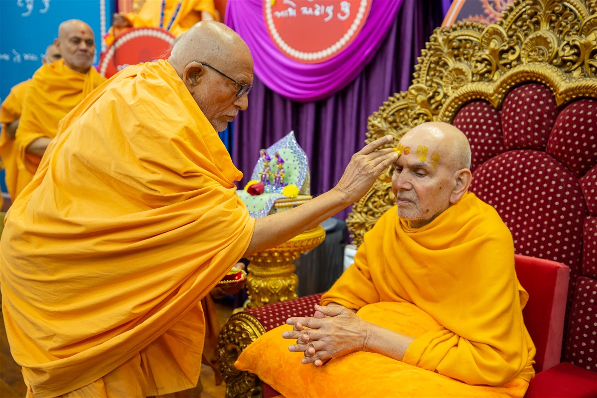 Pujya Kothari Swami applies chandan archa to Swamishri