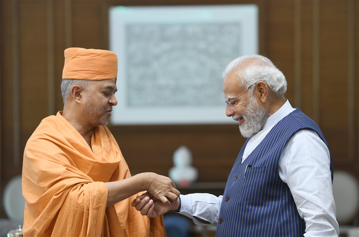 Swami Brahmaviharidas ties a Nadachhadi on PM Narendra Modi’s wrist
