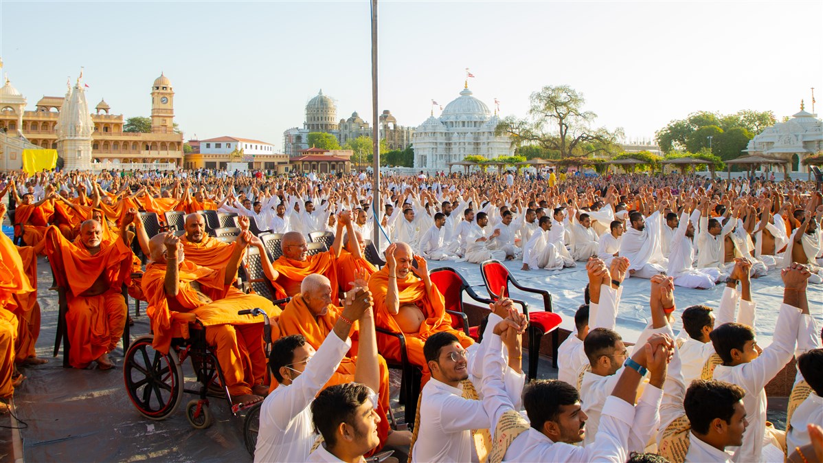 Sadhus and devotees join hands in a gesture of unity