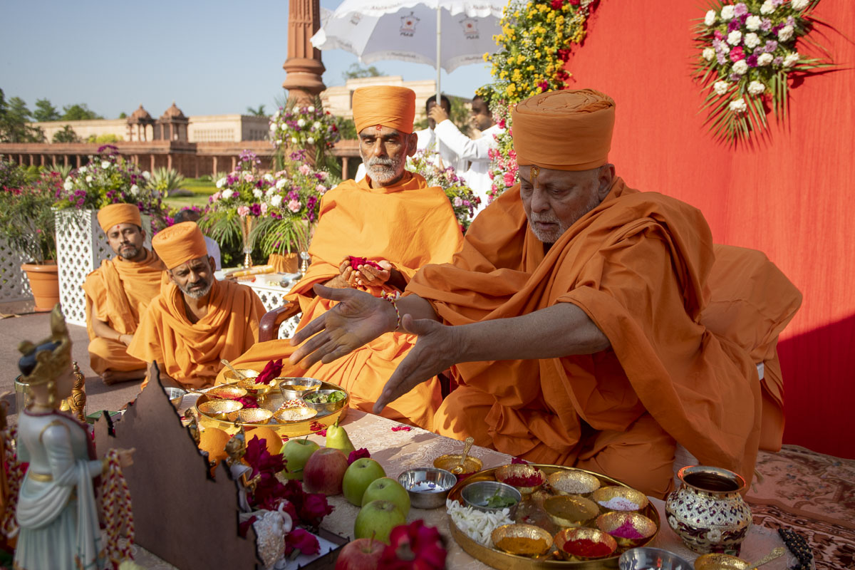 Pujya Ishwarcharan Swami and Anandswarup Swami offer mantra-pushpanjali